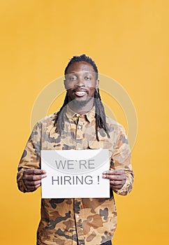 Entrepreneur holding hiring sign