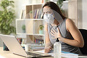 Entrepreneur with mask due covid-19 wheezing at homeoffice