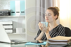 Entrepreneur resting drinking coffee at homeoffice photo