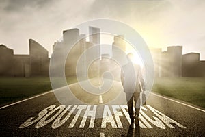 Entrepreneur with suitcase and South Africa word