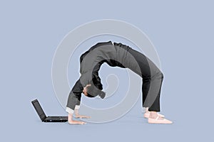 Entrepreneur uses a laptop with back bend pose