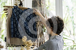 An entrepreneur woman in a clothe shop photo