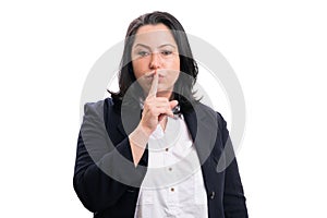 Entrepreneur woman shush gesture touching lips with finger