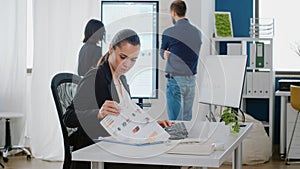 Entrepreneur working with computer and documents for project