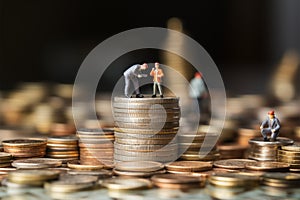 Entrepreneurial journey Miniature businesspeople on money with wooden background