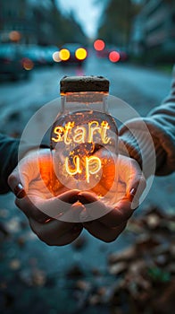 Entrepreneurial spirit captured as hands present the glowing words start up, symbolizing the inception and passion of new business