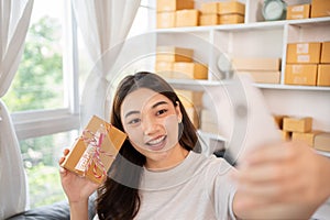 Entrepreneurial Woman Takes Selfies with Products for Online Sales