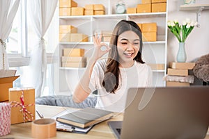 Entrepreneurial Woman Takes Selfies with Products for Online Sales