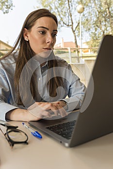 Entrepreneurial young woman working in the office with her laptop
