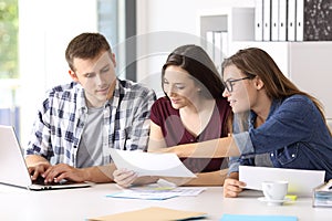 Entrepreneurs analyzing a report at office photo