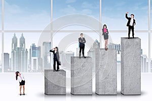 Entrepreneurs standing on the ranking bars photo