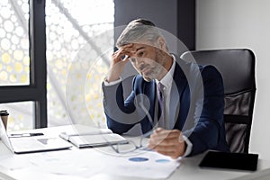 Entrepreneurship Crisis. Depressed Middle Aged Businessman Sitting At Workplace In Office