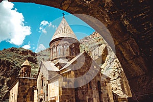 Entry through arch to cave monastery Geghard, Armenia. Armenian architecture. Pilgrimage place. Religion background. Travel concep