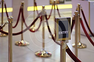 Entry / Exit sign against Rope Barrier Stanchion Queue Rope Barrier Posts Stands Crowd Control