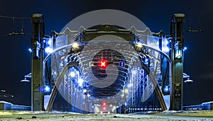 Entry to Bolsheokhtinsky bridge. Winter Saint Petersburg, Russia. Evening with night illumination. Red warning sign no entrance.