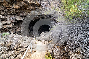 Entry to the mouth of the Sentinal Cave in Lava Beds National Monument in California photo