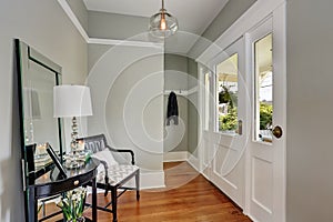 Entryway with gray walls, console table and wood floors