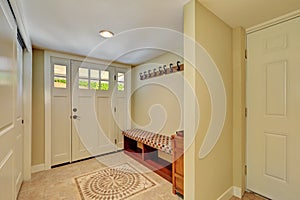 Entryway in light tones with mosaic tile floor