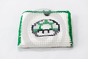 envelope for external hard drive, crocheted with a green mushroom drawn