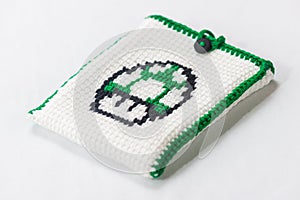 envelope for external hard drive, crocheted with a green mushroom drawn