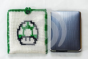 envelope for external hard drive, crocheted with a green mushroom drawn