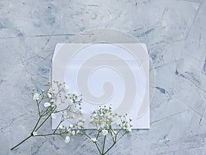 Envelope flower beautiful  greeting  on concrete backgroundn floral invitation photo