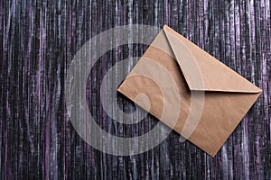 Envelope of Kraft paper. Love letter envelope. Wooden background. Social network.