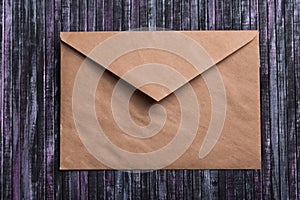 Envelope of Kraft paper. Love letter envelope. Wooden background. Social network.