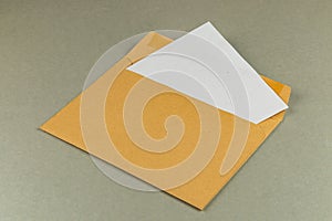 Envelope with a letter partially pulled out on a neutral surface