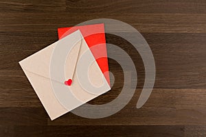Envelope Love Letter. Tow Envelopes Red and Brown with a Heart on Wood Pattern