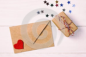 Envelope Mail with Red Heart and gift box over White toned, vintage Wooden Background. Valentine Day Card, Love or Wedding