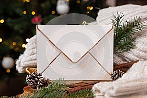 Envelope nearpine cones, spices, white knitted sweater and fir twigs. Christmas mockup