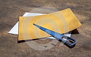 Envelope opener knife made of Stainless steel and two letter envelope on old wooden desk