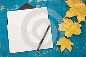 Envelope, pen and autumn leaves