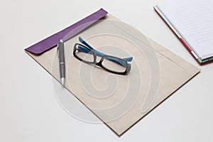 Envelope pen and glasses normal object in working