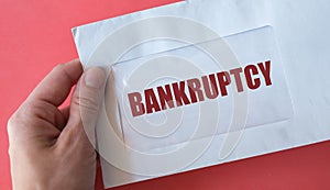 Envelope with text BANKRUPTCY - legal process when one cannot repay debts to creditors and seek relief from some or all debts -