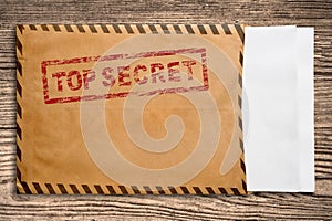 Envelope with top secret stamp and blank papers.