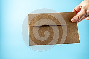 Envelope on a wooden table, blue background