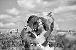 An enviable groom. wedding couple kiss in field yellow flowers