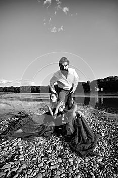 An enviable man. Bearded man and two women outdoor