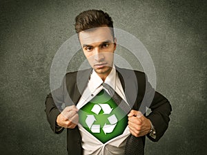 Enviromentalist business man tearing off shirt with recycle sign