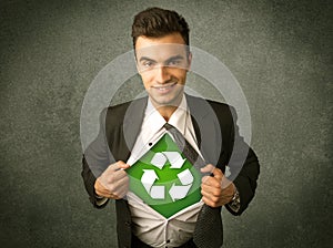 Enviromentalist business man tearing off shirt with recycle sign