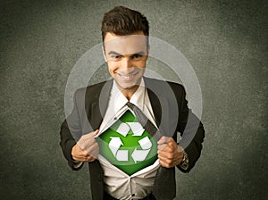 Enviromentalist business man tearing off shirt with recycle sign