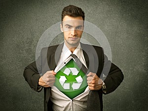 Enviromentalist business man tearing off shirt with recycle sign