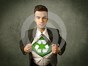 Enviromentalist business man tearing off shirt with recycle sign