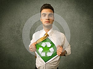 Enviromentalist business man tearing off shirt with recycle sign