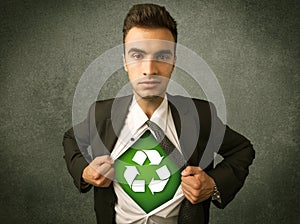 Enviromentalist business man tearing off shirt with recycle sign