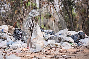 environment Earth Day, Child sitting to separate garbage to be recycled. The concept helps reduce air pollution and protect the