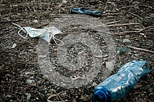Environment. Plastic garbage in woodland. Rubbish trash, waste and medical mask in forest. Ecological problem with Empty