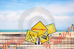 Environment, society and economics written on yellow sign on plank and beach background